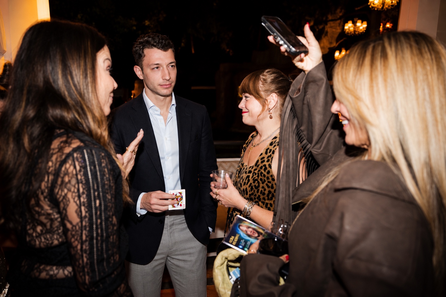Kassim performing close-up magic at an elegant evening event